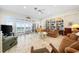 Bright and spacious living room boasts an ocean view, large windows, and a built-in bookcase at 8592 Hidden Lagoon Rd, Sarasota, FL 34242