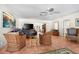 Cozy sitting room with wicker chairs, tiled floors, and bright, neutral walls at 8592 Hidden Lagoon Rd, Sarasota, FL 34242