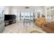 Bright living room featuring an ocean view, comfortable seating, and plantation shutters for natural light control at 8592 Hidden Lagoon Rd, Sarasota, FL 34242