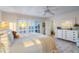 Sunny main bedroom featuring whitewashed floors, shuttered windows with ocean views, and a white dresser at 8592 Hidden Lagoon Rd, Sarasota, FL 34242
