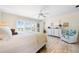 Bright main bedroom boasts whitewashed floors, shuttered windows with ocean views, and a cozy seating area at 8592 Hidden Lagoon Rd, Sarasota, FL 34242