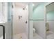 Clean, modern shower with white subway tiles, a glass door, and built-in shelving at 8592 Hidden Lagoon Rd, Sarasota, FL 34242