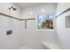 Bright shower with white tile, a window with a view, and a built-in bench at 8592 Hidden Lagoon Rd, Sarasota, FL 34242