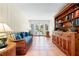 Cozy sitting room featuring nautical decor, wicker furniture, built-in bookshelves, and a view to the backyard at 8592 Hidden Lagoon Rd, Sarasota, FL 34242