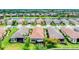 An aerial view of well-maintained homes with red tile roofs along a picturesque lake at 8721 Trattoria Ter, Sarasota, FL 34238