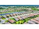 An aerial view of an upscale community with a lake, lush landscaping, and beautiful homes at 8721 Trattoria Ter, Sarasota, FL 34238