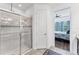 Bathroom with walk-in shower, view to the bedroom and neutral tile flooring at 8721 Trattoria Ter, Sarasota, FL 34238