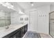 Bright bathroom with double vanity, walk-in shower, and neutral tile flooring, offering a spa-like experience at 8721 Trattoria Ter, Sarasota, FL 34238