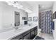 Well-lit bathroom features double vanity, granite countertops, and tiled shower at 8721 Trattoria Ter, Sarasota, FL 34238