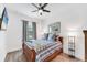 Comfortable bedroom with wood floors, ceiling fan, and plenty of natural light at 8721 Trattoria Ter, Sarasota, FL 34238