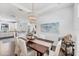 Open concept dining area with modern chandelier and views into the kitchen and living spaces at 8721 Trattoria Ter, Sarasota, FL 34238