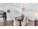 Bright dining area featuring hardwood floors, modern lighting and decor, perfect for gatherings at 8721 Trattoria Ter, Sarasota, FL 34238