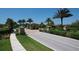Community entrance featuring manicured landscaping, elegant stone pillars, and a decorative gatehouse at 8721 Trattoria Ter, Sarasota, FL 34238