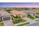 Beautiful single-story home with a terracotta-colored tile roof, lush landscaping, and a two-car garage at 8721 Trattoria Ter, Sarasota, FL 34238