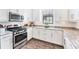 Bright kitchen featuring granite countertops and stainless steel appliances at 8721 Trattoria Ter, Sarasota, FL 34238