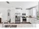 Modern kitchen features stainless appliances and white cabinetry at 8721 Trattoria Ter, Sarasota, FL 34238