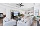 Bright living room with ceiling fan, hardwood floors, and modern decor at 8721 Trattoria Ter, Sarasota, FL 34238