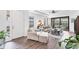 Bright living room with hardwood floors, high ceilings, and sliding doors to the outdoors at 8721 Trattoria Ter, Sarasota, FL 34238