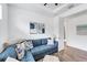 Comfortable blue sectional sofa with decorative pillows and a view of the doorway to the bathroom at 8721 Trattoria Ter, Sarasota, FL 34238