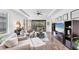 Open living room with wood floors, neutral furniture, tray ceiling, and backyard views at 8721 Trattoria Ter, Sarasota, FL 34238