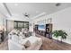 Spacious living room featuring tray ceilings, hardwood flooring, and access to an outdoor patio at 8721 Trattoria Ter, Sarasota, FL 34238