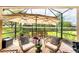 Relaxing screened patio area with comfortable seating and lush landscaping at 8721 Trattoria Ter, Sarasota, FL 34238