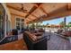 Outdoor lounge area with stylish seating, ceiling fans, and views of the community pool at 8721 Trattoria Ter, Sarasota, FL 34238