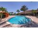 Community swimming pool with lounge chairs and tropical landscaping providing a resort-like experience at 8721 Trattoria Ter, Sarasota, FL 34238
