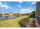 Backyard view of a serene lake and houses within a well-maintained community, perfect for relaxation at 8824 Havenridge Dr, Sarasota, FL 34238