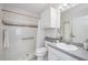 Clean, white bathroom featuring a shower with grab bar, vanity, and updated fixtures at 8824 Havenridge Dr, Sarasota, FL 34238