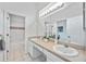 Bright bathroom featuring double sinks, vanity area, and access to a shower and toilet at 8824 Havenridge Dr, Sarasota, FL 34238