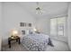 Bright bedroom featuring a ceiling fan, patterned bedding, and natural light from a window at 8824 Havenridge Dr, Sarasota, FL 34238