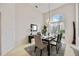 Elegant dining room with high ceilings, a chandelier, and a large window overlooking the front yard at 8824 Havenridge Dr, Sarasota, FL 34238
