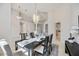 Bright dining room with modern chandelier, table, and chair set with decorative centerpieces at 8824 Havenridge Dr, Sarasota, FL 34238