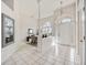 Bright foyer with tile flooring, high ceilings, an arched window, and an adjacent dining area at 8824 Havenridge Dr, Sarasota, FL 34238