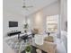 Comfortable living room with neutral colors, a ceiling fan, large windows, and a gray area rug at 8824 Havenridge Dr, Sarasota, FL 34238