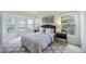 Light-filled main bedroom with serene views from many windows, complemented by a stylish bed and tranquil decor at 8824 Havenridge Dr, Sarasota, FL 34238