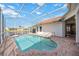 Screened-in pool with paved patio and steps features calming views of the neighborhood lake at 8824 Havenridge Dr, Sarasota, FL 34238