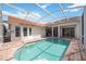 Screened-in pool and patio area features a calm lake view, tile roof, and access to the home at 8824 Havenridge Dr, Sarasota, FL 34238