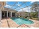 Relaxing screened-in pool and patio offers a view of the neighborhood with lake and surrounding homes at 8824 Havenridge Dr, Sarasota, FL 34238
