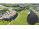 Scenic aerial view of property featuring well-maintained landscaping, golf course, and pond at 9630 Club South Cir # 6209, Sarasota, FL 34238