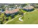 Scenic aerial view of property featuring well-maintained landscaping, golf course, pond, and tennis court at 9630 Club South Cir # 6209, Sarasota, FL 34238
