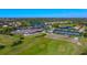 An aerial view showcases the community's golf course, clubhouse, pools, tennis courts, and surrounding neighborhood at 9630 Club South Cir # 6209, Sarasota, FL 34238