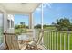Outdoor balcony with seating featuring views of lush greenery and the golf course at 9630 Club South Cir # 6209, Sarasota, FL 34238