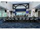 A modern bar area features a large counter, comfortable seating, and multiple TVs for entertainment at 9630 Club South Cir # 6209, Sarasota, FL 34238