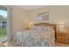 Comfortable bedroom featuring light color palette, wood floors and a sliding door to a balcony at 9630 Club South Cir # 6209, Sarasota, FL 34238