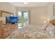 Comfortable bedroom featuring a light color palette, wood floors, and a sliding door to a balcony at 9630 Club South Cir # 6209, Sarasota, FL 34238