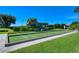Well-maintained bocce court with manicured grass, a shaded seating area, and a peaceful outdoor setting at 9630 Club South Cir # 6209, Sarasota, FL 34238