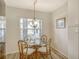 Cozy dining area featuring a glass table, rattan chairs and a window for natural light at 9630 Club South Cir # 6209, Sarasota, FL 34238