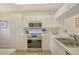 Kitchen featuring white cabinetry, stainless steel appliances and ample countertop space at 9630 Club South Cir # 6209, Sarasota, FL 34238
